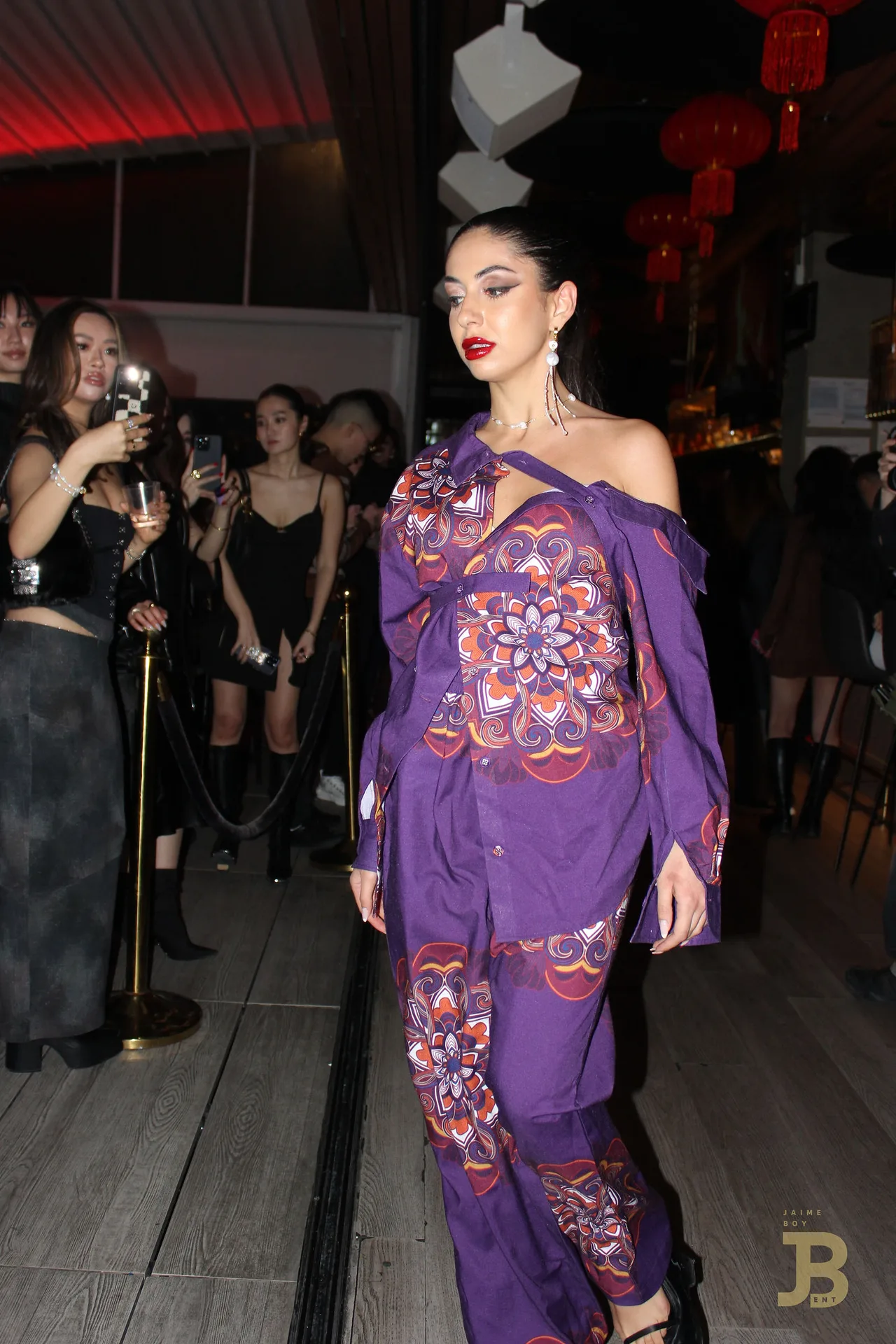 A model in a purple floral kimono-style jacket and trousers.